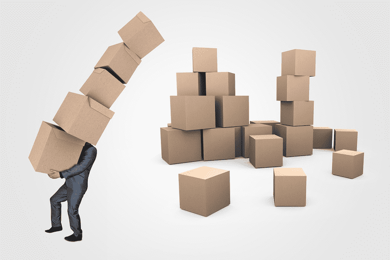 Man carrying 5 boxes that are about to topple over